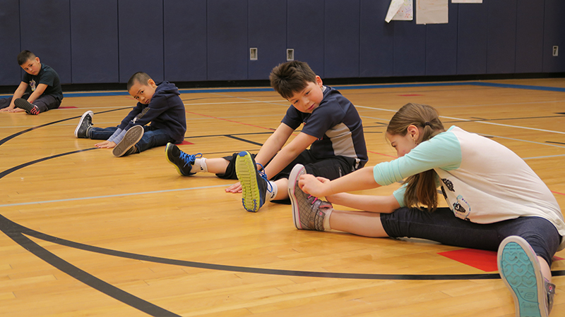 Students stretch during PE Class