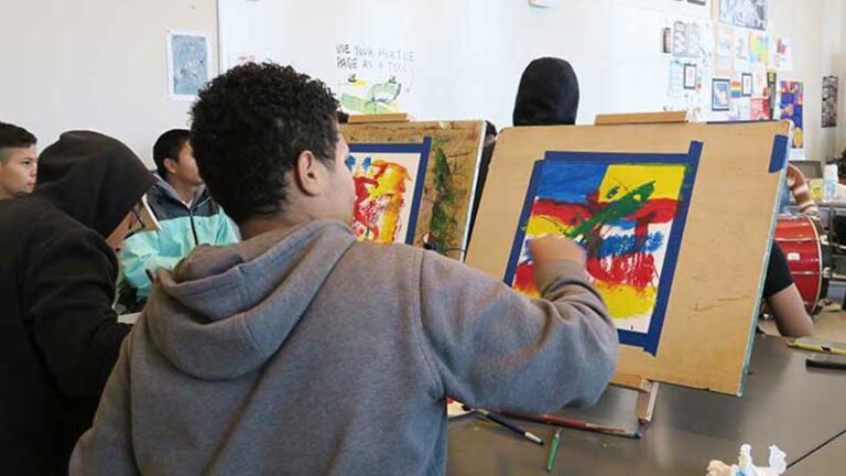 Painting students create works of art.