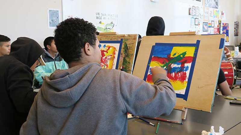 Painting students create works of art.