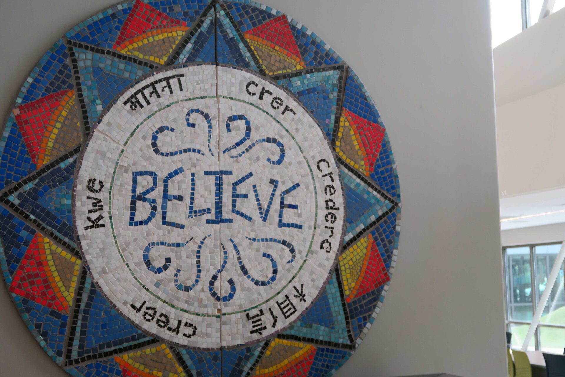 colorful mosaic medallion that says Believe in the center at the East Somerville